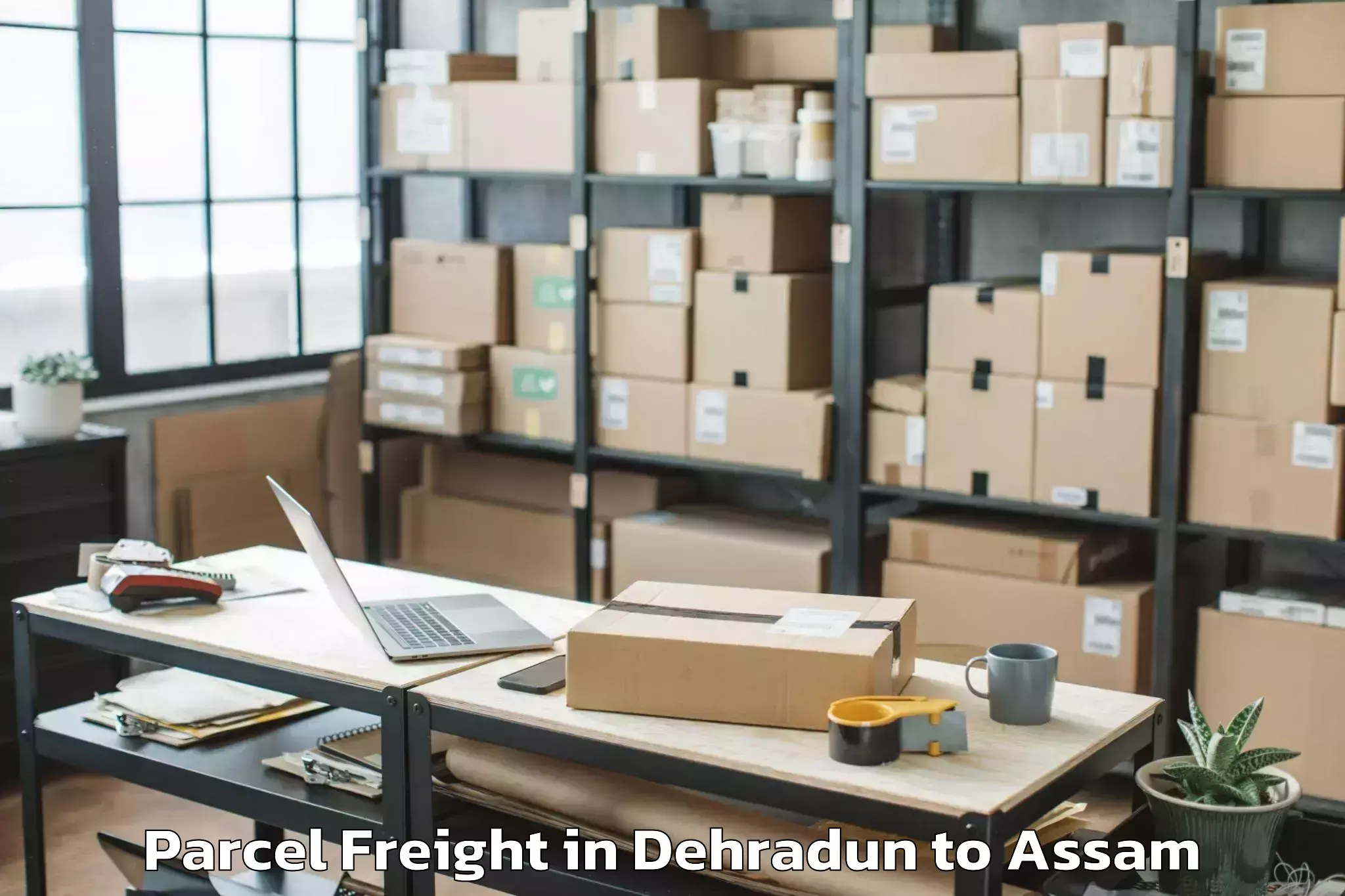 Book Dehradun to Hamren Parcel Freight Online